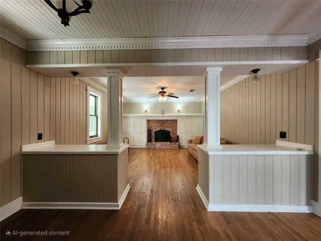 a view of a livingroom with a fireplace and wooden floor