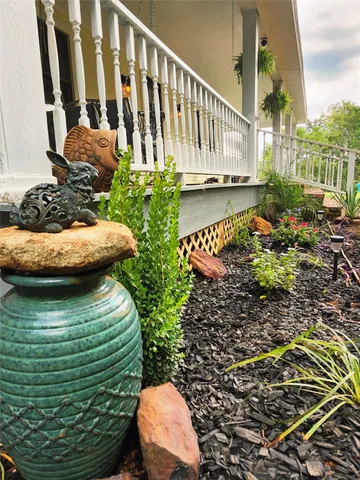 a view of a garden with wooden fence