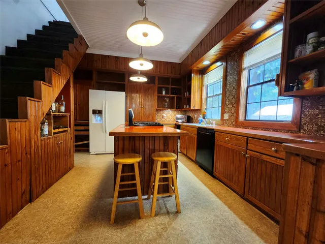 an open kitchen with a table and chairs