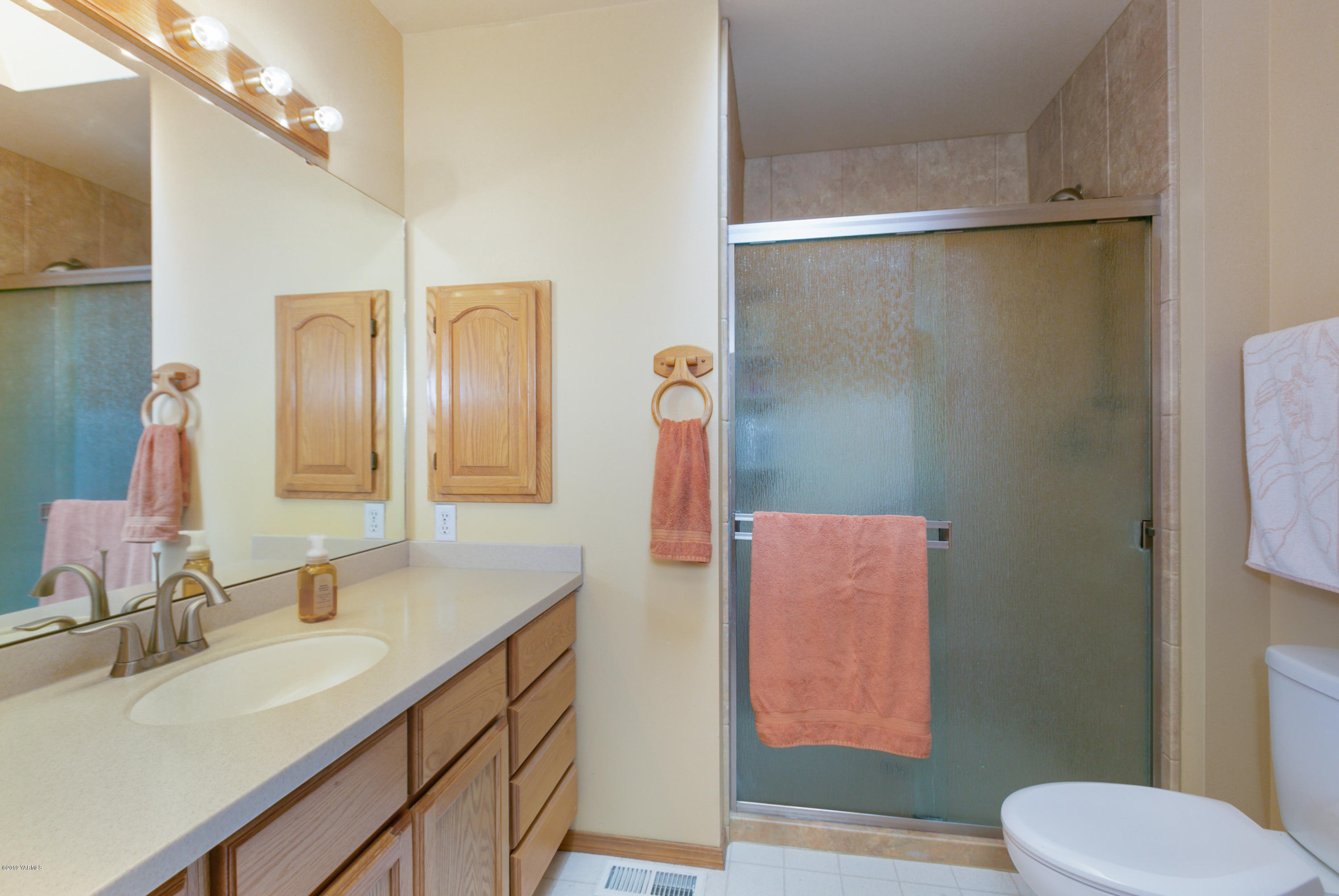 10501 Summitview Road Yakima, WA 98908 - Photo 12 of 22 a bathroom with a double vanity sink mirror and toilet