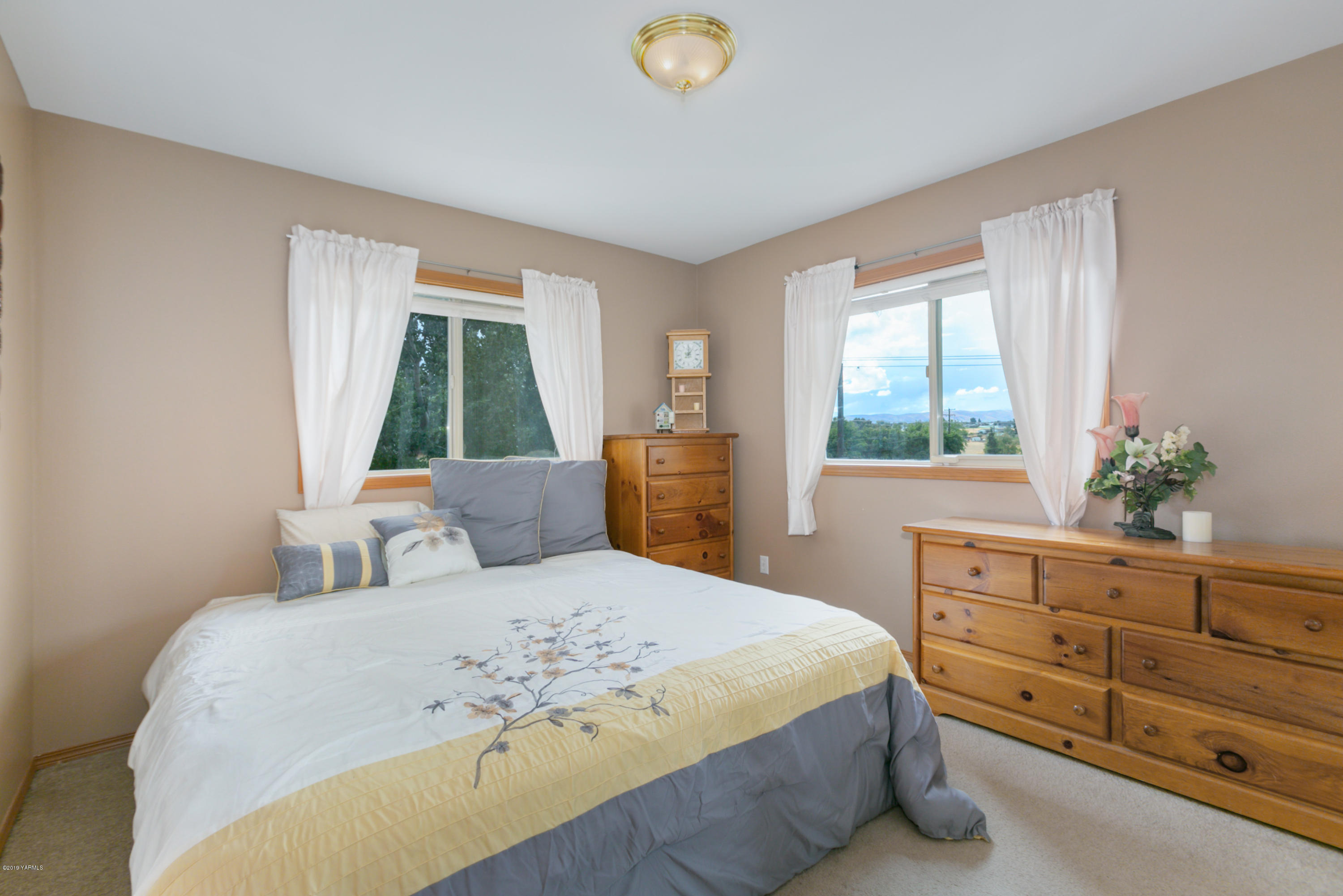 10501 Summitview Road Yakima, WA 98908 - Photo 13 of 22 a bedroom with a large bed and a window