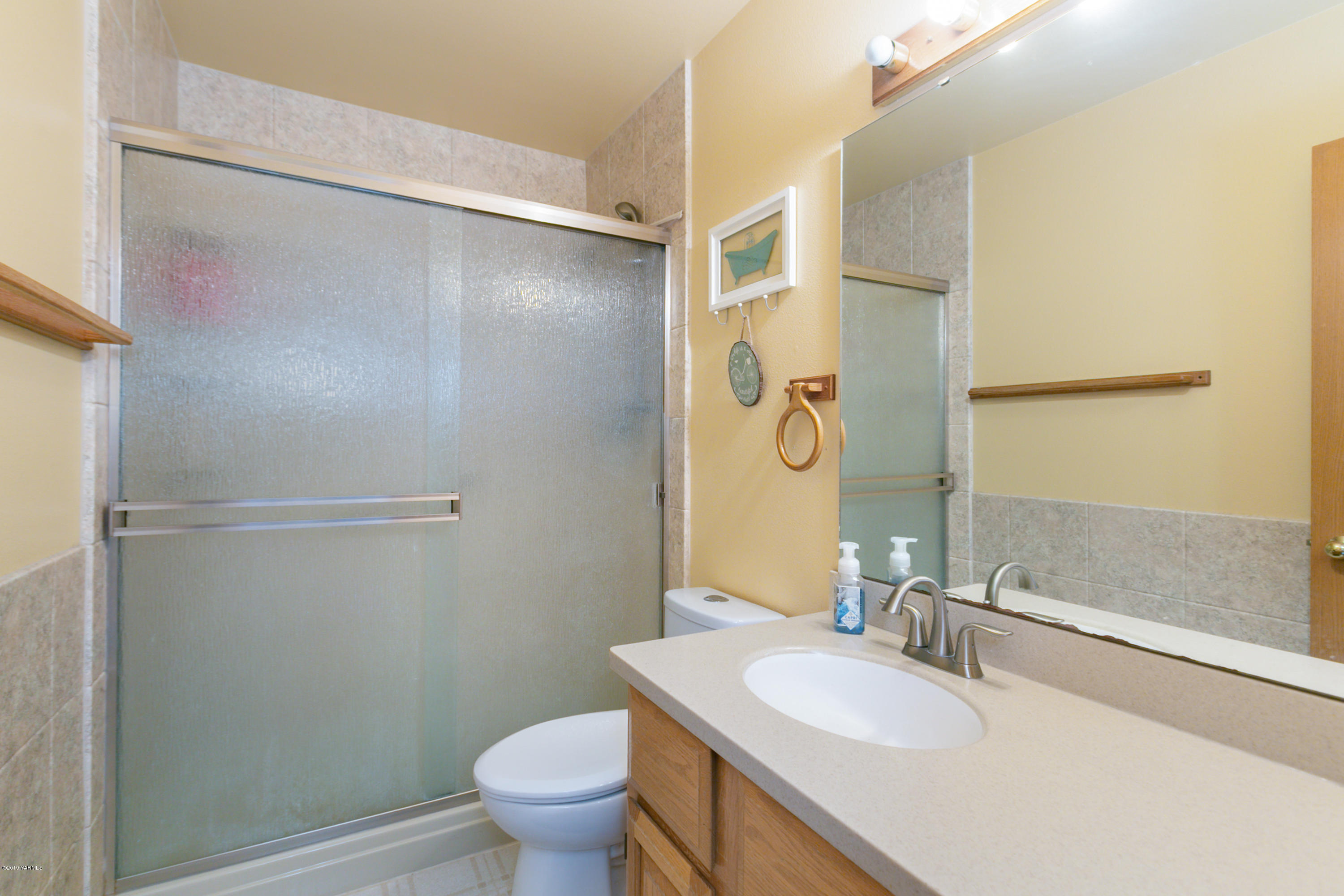 10501 Summitview Road Yakima, WA 98908 - Photo 14 of 22 a bathroom with a granite countertop sink toilet and shower