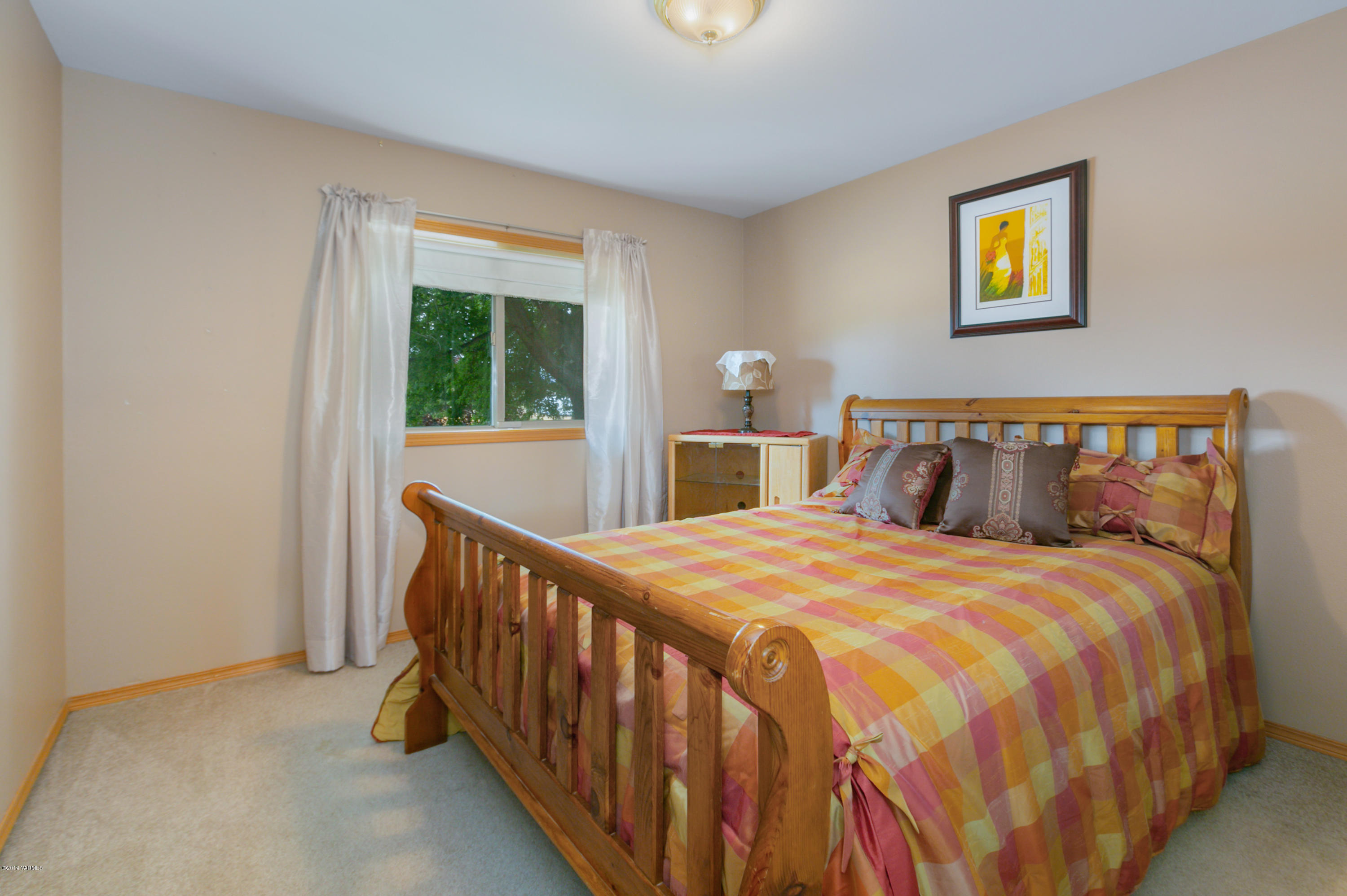 10501 Summitview Road Yakima, WA 98908 - Photo 16 of 22 a bedroom with a bed and a window