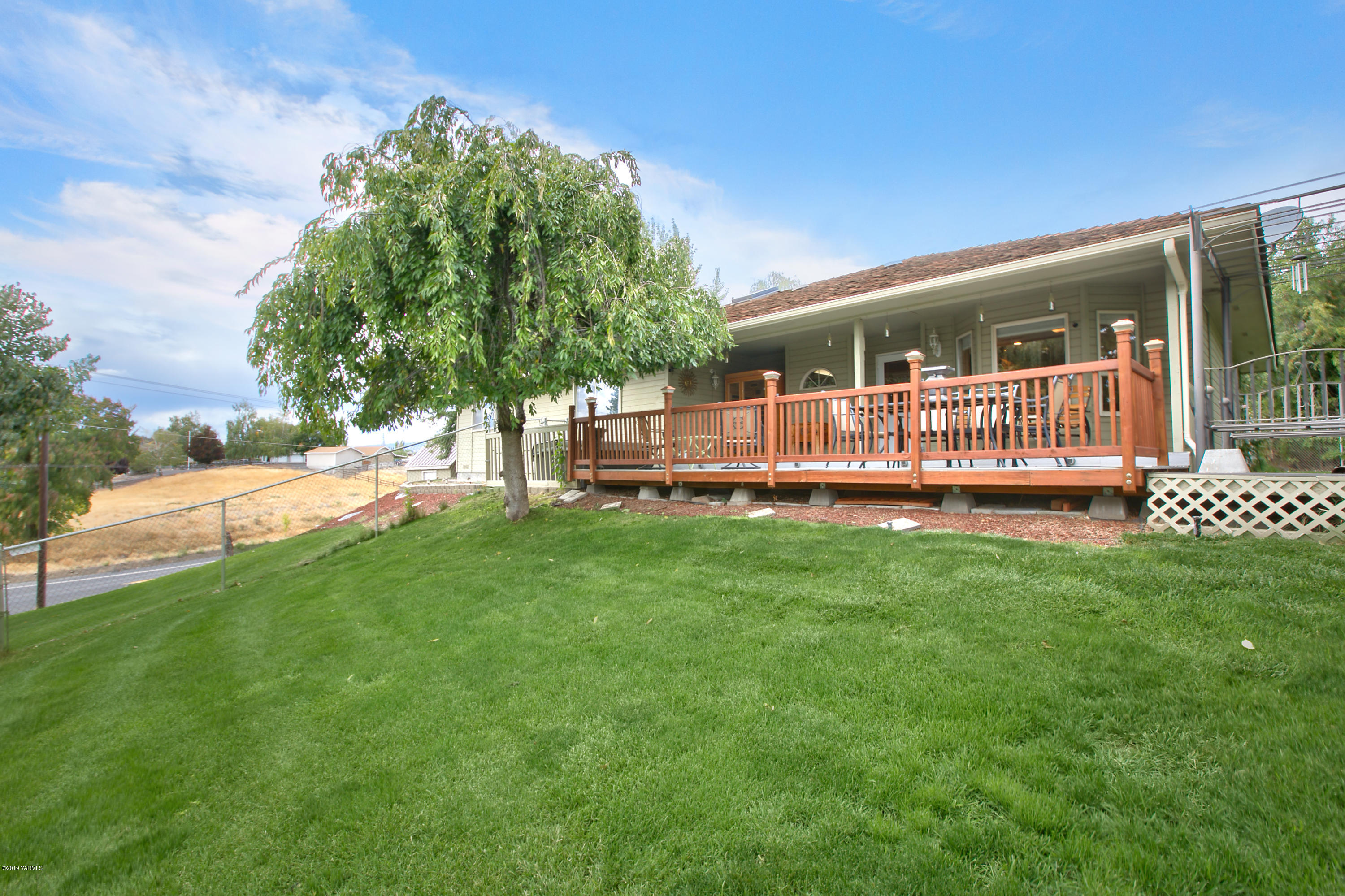 10501 Summitview Road Yakima, WA 98908 - Photo 18 of 22 a view of backyard with deck and garden