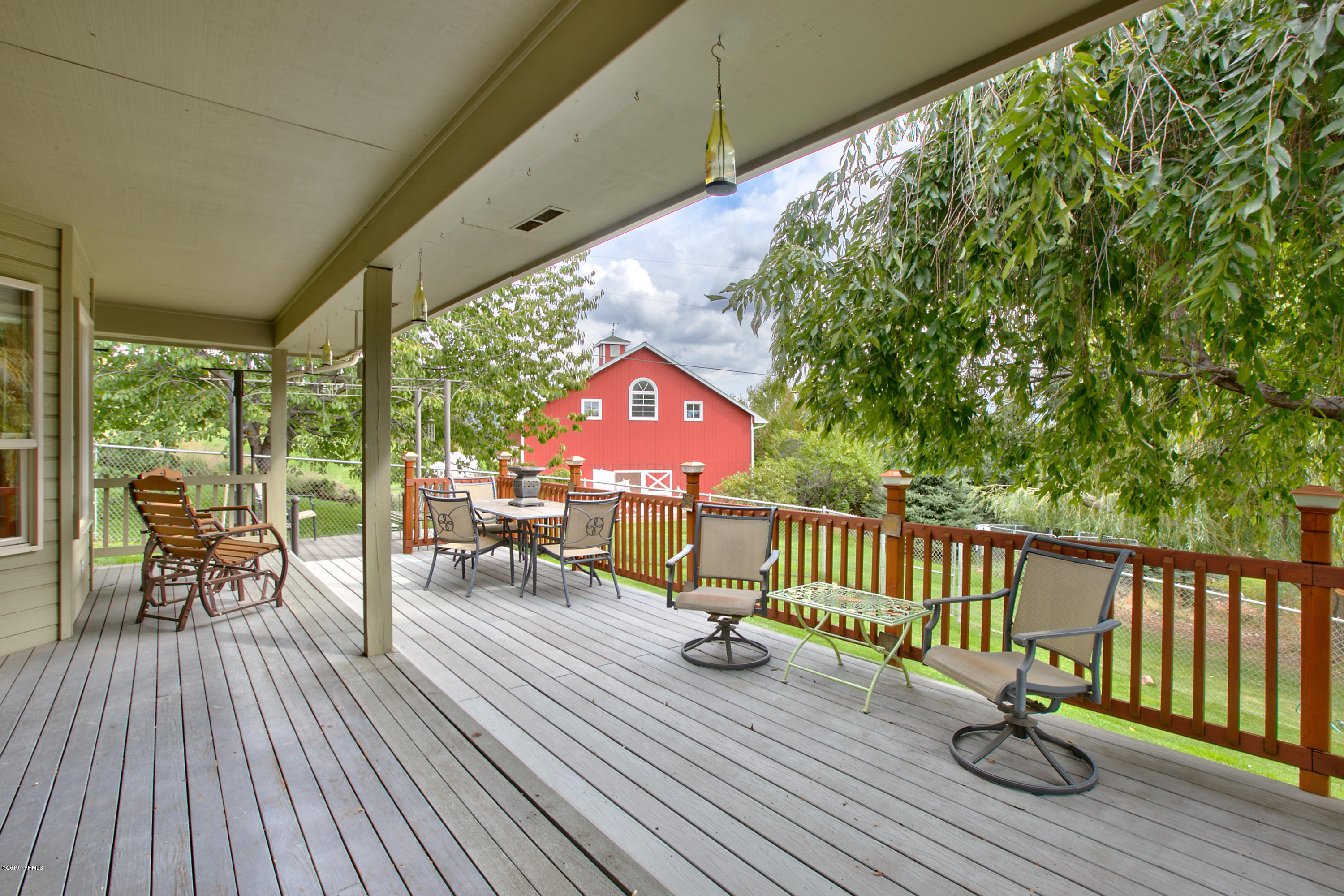 10501 Summitview Road Yakima, WA 98908 - Photo 20 of 22 a view of balcony with wooden floor and outdoor seating