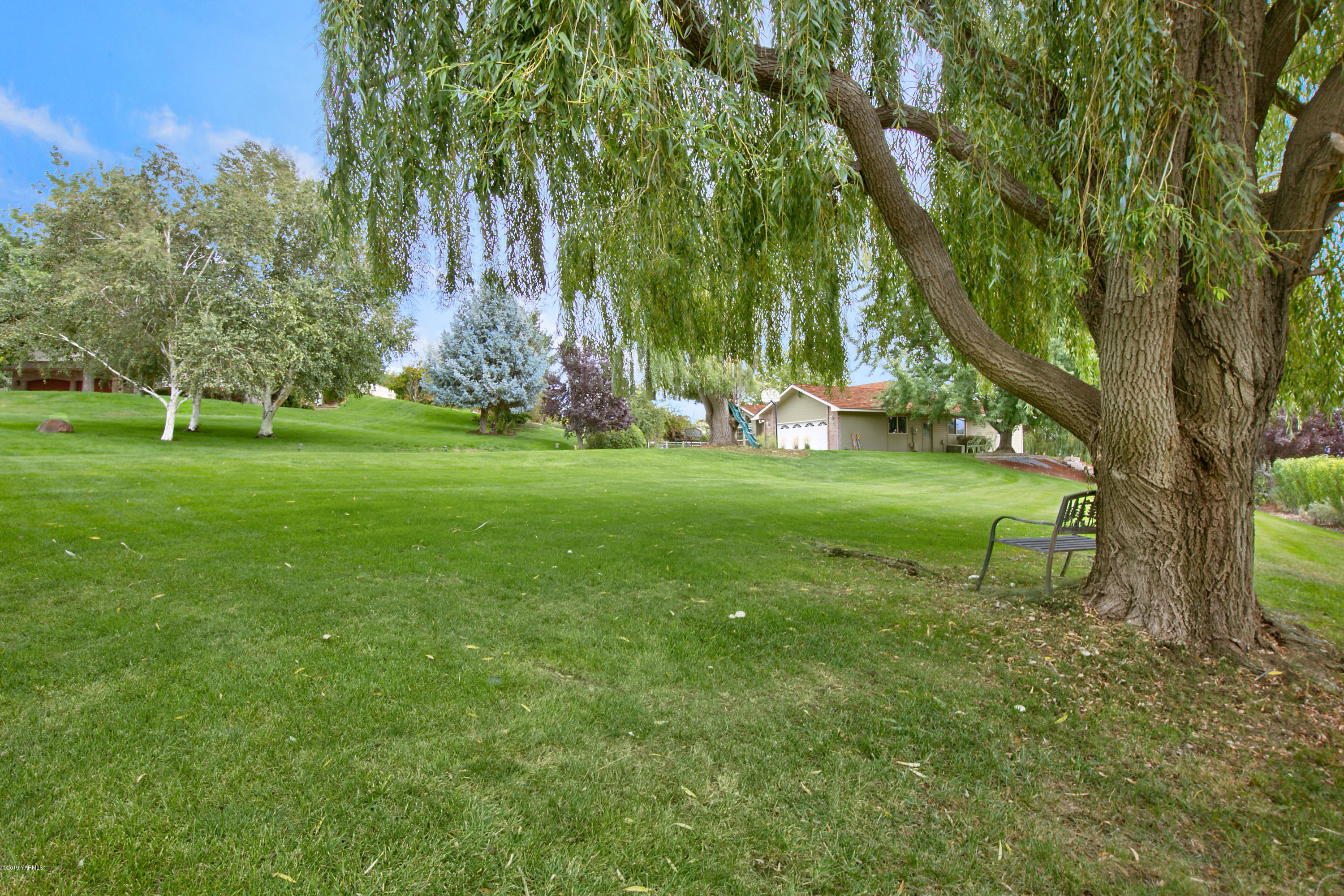 10501 Summitview Road Yakima, WA 98908 - Photo 21 of 22 a backyard of a house with lots of green space