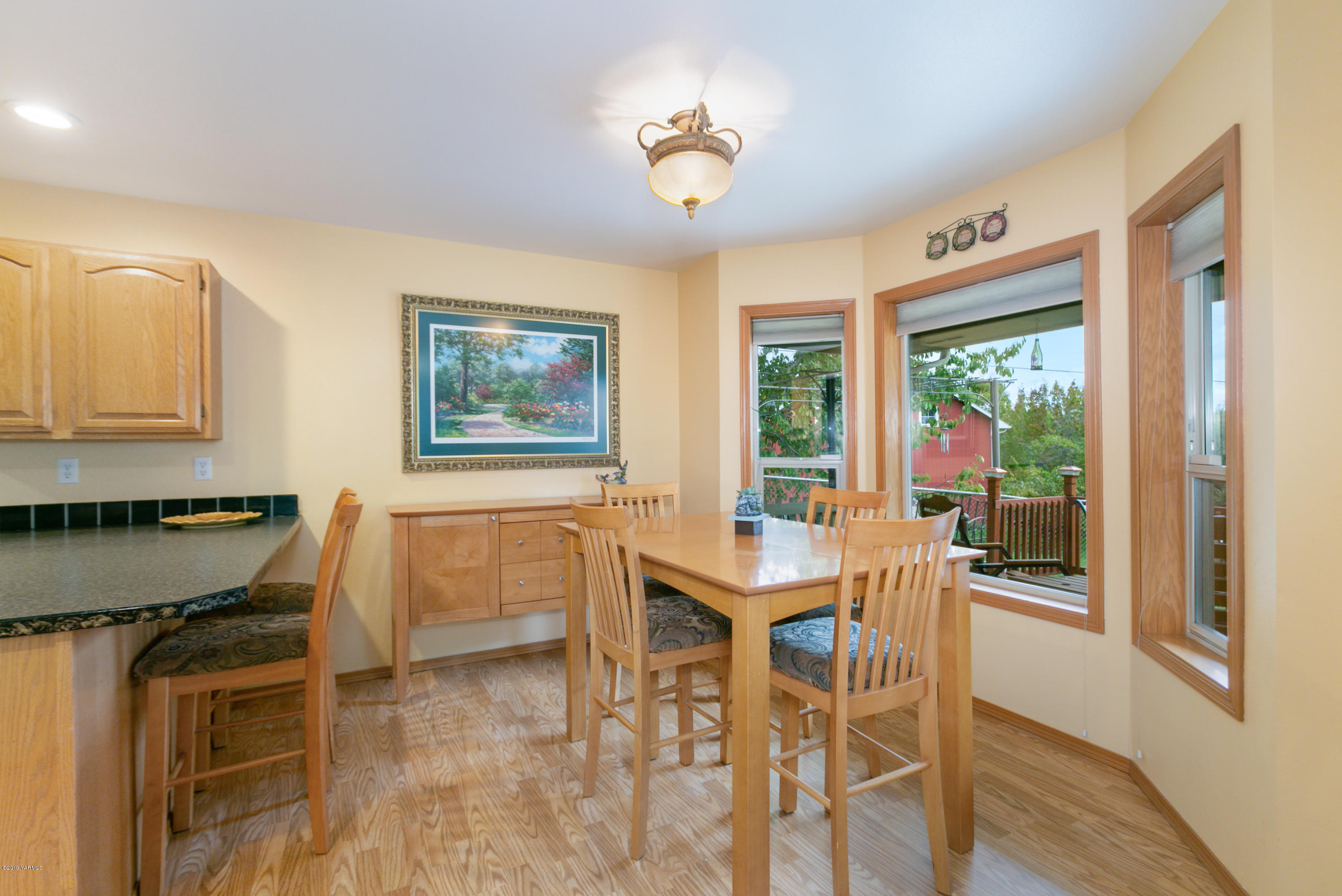 10501 Summitview Road Yakima, WA 98908 - Photo 8 of 22 a dining room with furniture a window and wooden floor