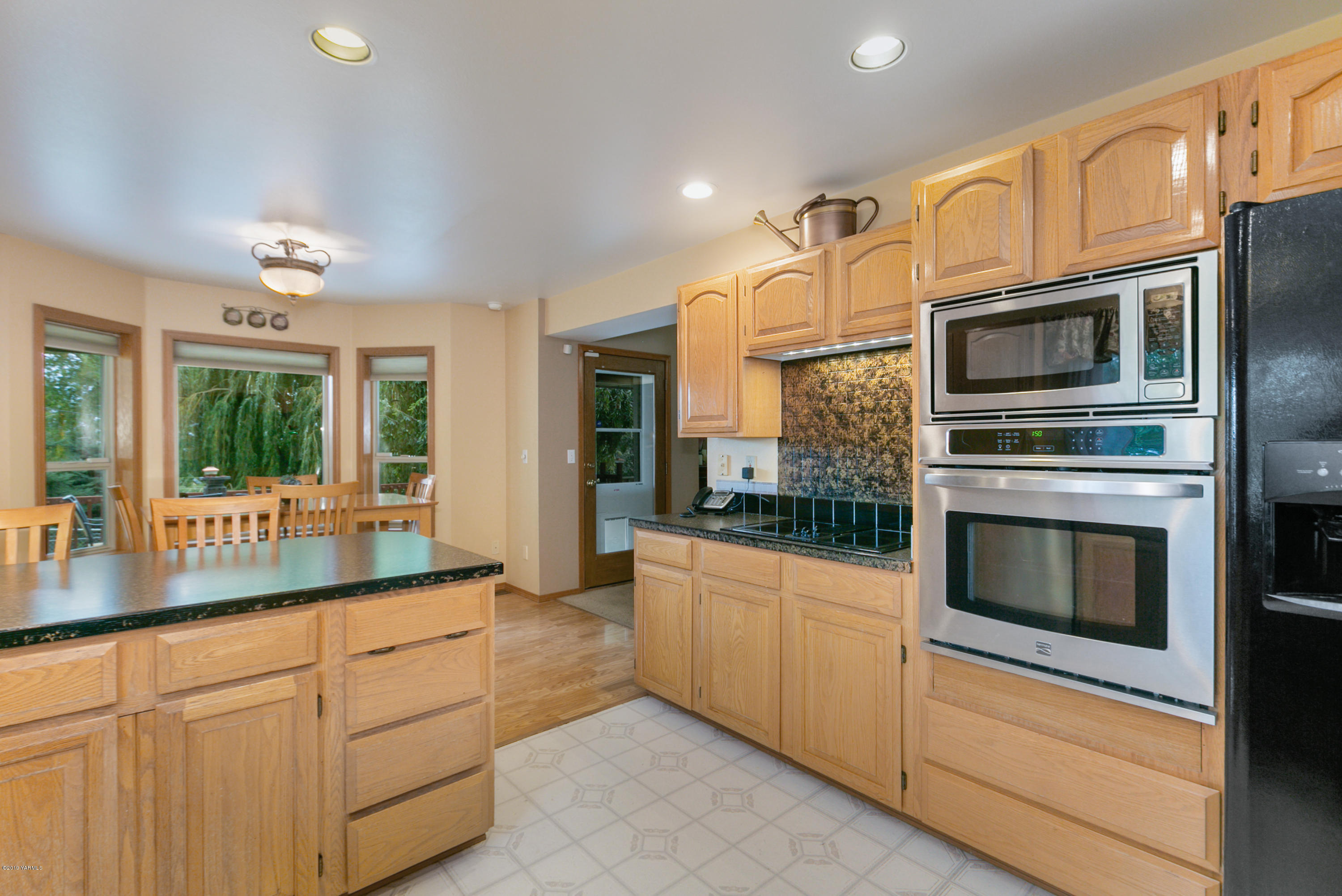 10501 Summitview Road Yakima, WA 98908 - Photo 10 of 22 a kitchen with stainless steel appliances granite countertop a stove and cabinets