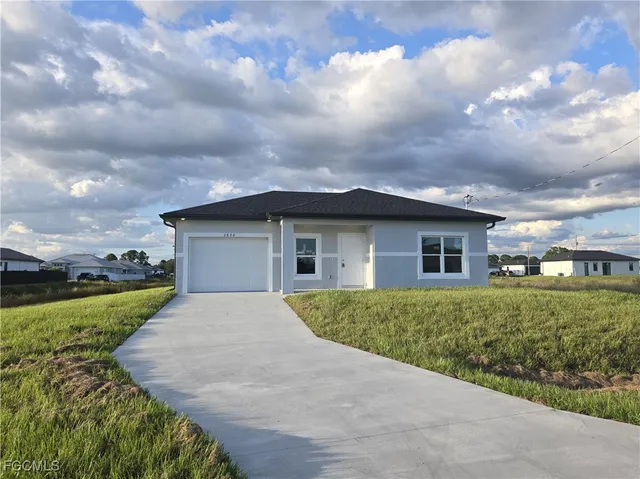 a front view of a house with a yard and garage