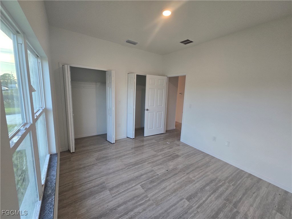 2822 19th Street Southwest Lehigh Acres, FL 33976 - Photo 13 of 23 a view of a livingroom with wooden floor and a staircase