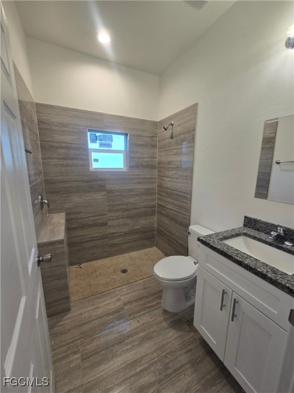 2822 19th Street Southwest Lehigh Acres, FL 33976 - Photo 14 of 23 a bathroom with a granite countertop toilet a sink and a shower