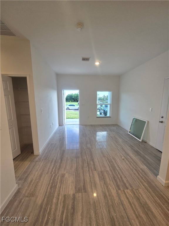 2822 19th Street Southwest Lehigh Acres, FL 33976 - Photo 3 of 23 wooden floor in an empty room with a window