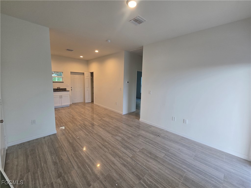 2822 19th Street Southwest Lehigh Acres, FL 33976 - Photo 6 of 23 a view of a kitchen with wooden floor and a sink