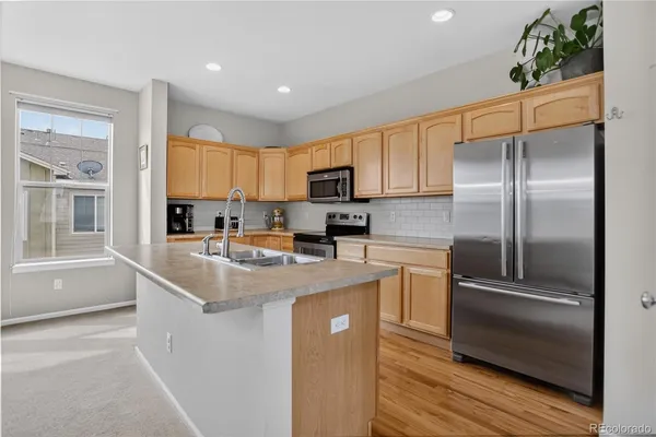 a kitchen with a sink stove and cabinets