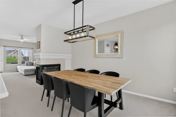 a view of a dining room and livingroom with furniture and window