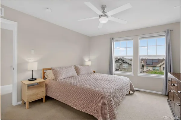 a bedroom with a large bed and a chandelier