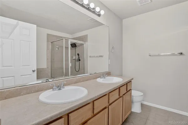 a bedroom with a bed table chair and a window