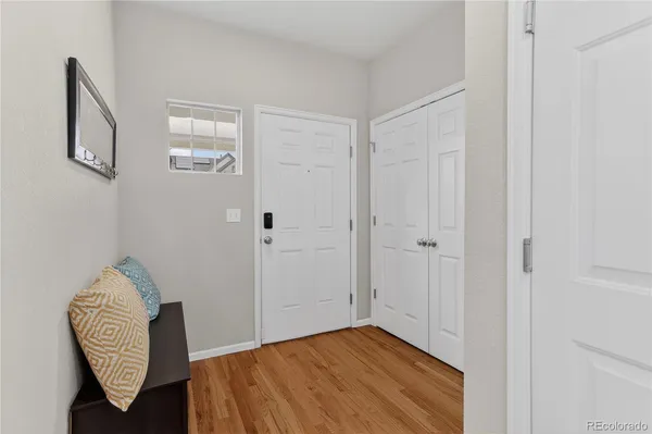 a view of empty room with wooden floor