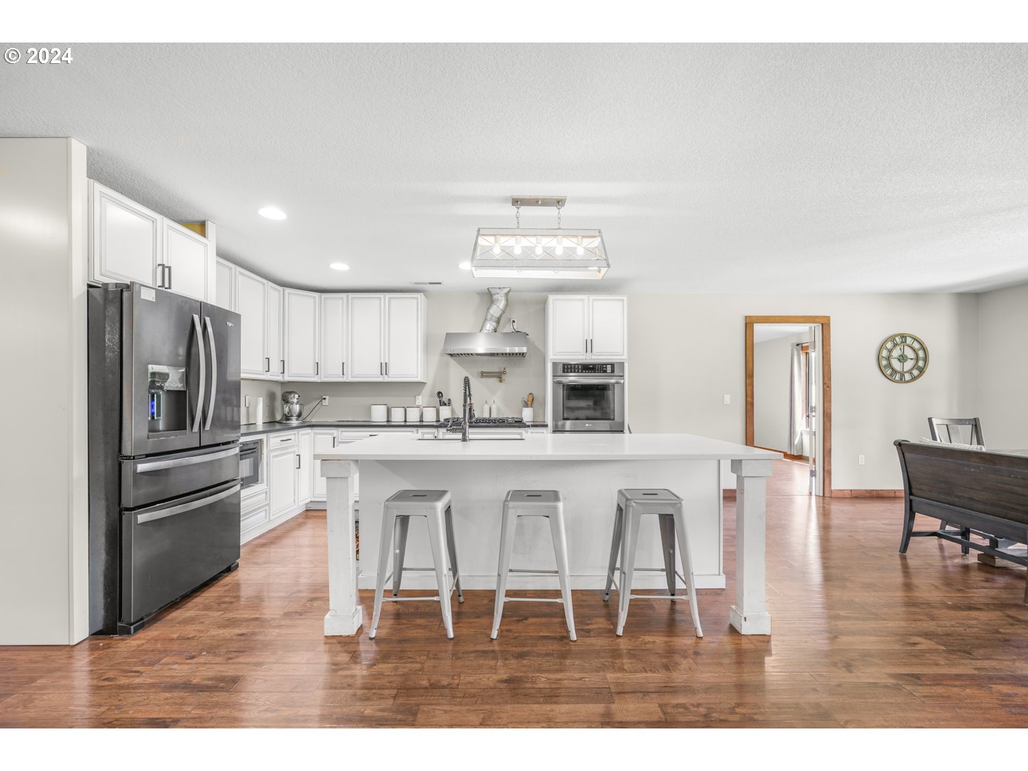 70200 Apiary Road Rainier, OR 97048 - Photo 11 of 37 a kitchen with stainless steel appliances granite countertop a stove a refrigerator a kitchen island and chairs