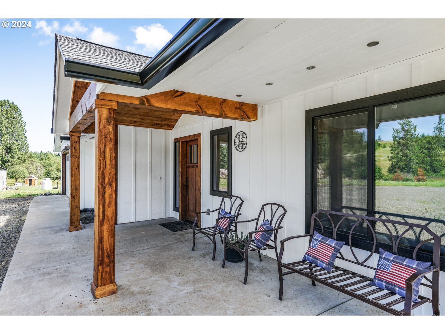 70200 Apiary Road Rainier, OR 97048 - Photo 27 of 37 a view of a patio with table and chairs and floor to ceiling window