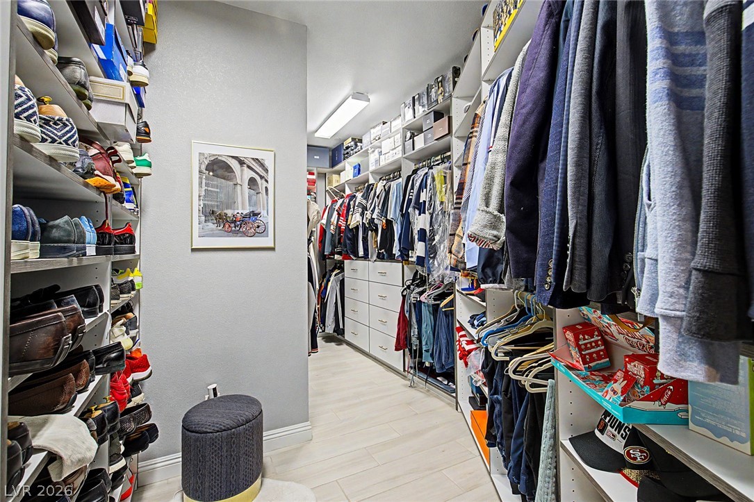 6014 Willow Ridge Court Las Vegas, NV 89135 - Photo 50 of 99 This organized walk-in closet features ample storage with shelving and hanging space for an impressive collection.