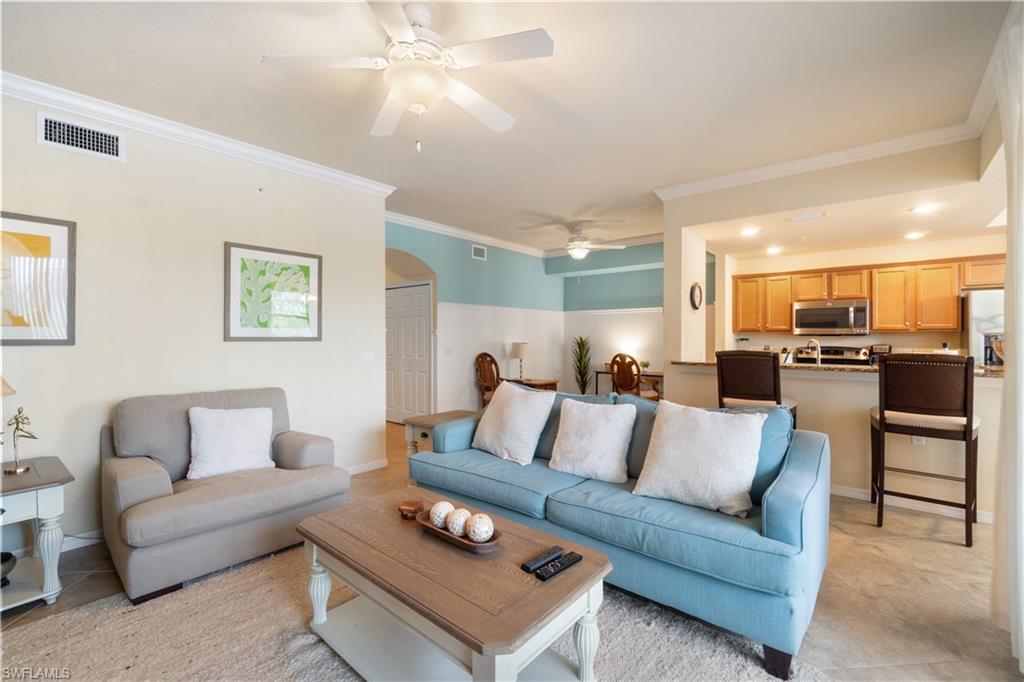 9727 Acqua Court, Unit 436 Naples, FL 34113 - Photo 4 of 40 a living room with furniture and kitchen view