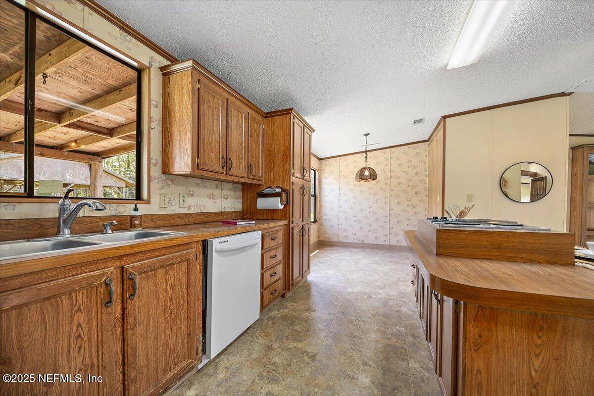 6370 CR 208 St. Augustine, FL 32092 - Photo 11 of 19 a kitchen with stainless steel appliances granite countertop a sink stove and cabinets