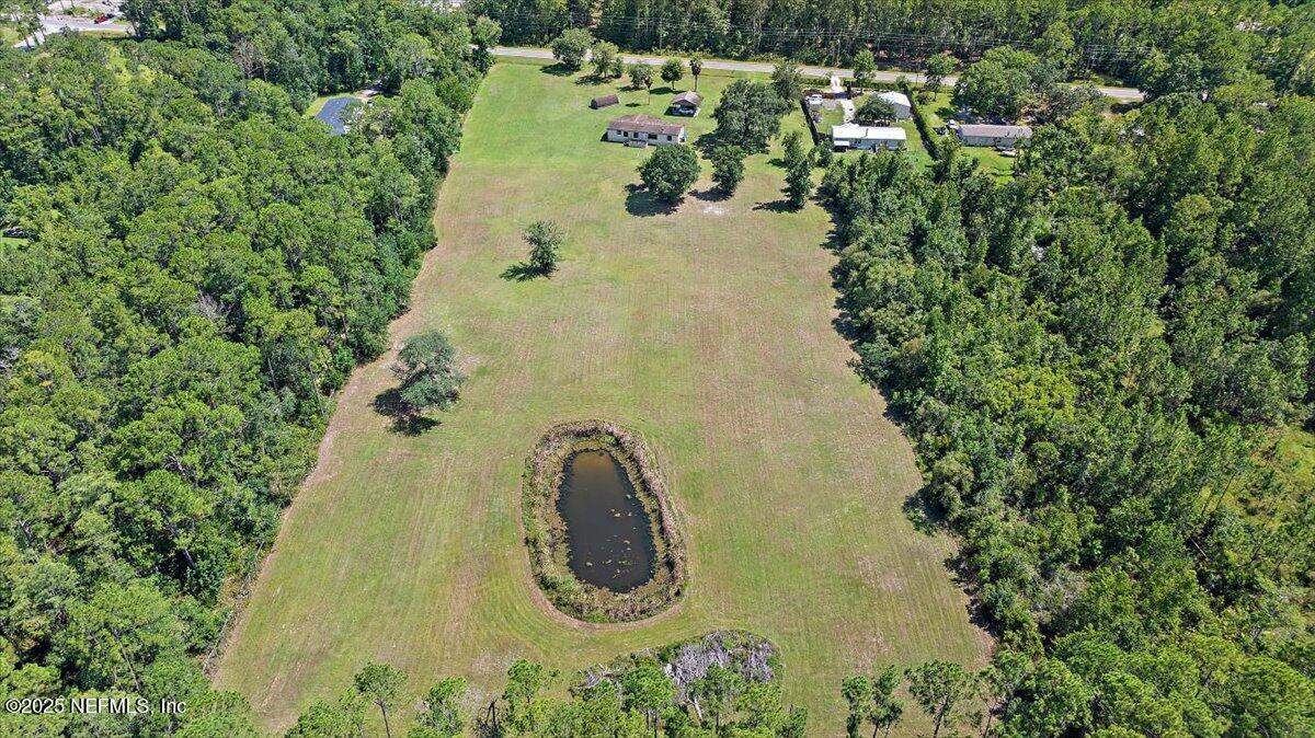 6370 CR 208 St. Augustine, FL 32092 - Photo 2 of 19 an aerial view of a house with a yard and trees all around