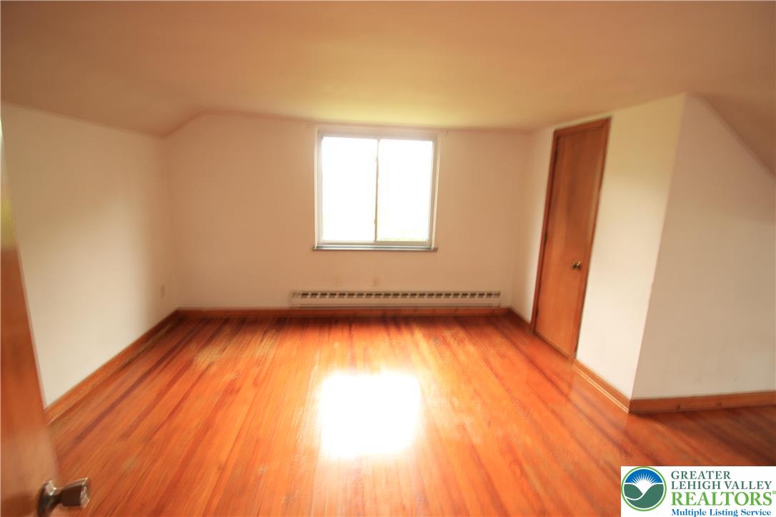 419 Diamond Street, Unit B Slatington, PA 18080 - Photo 14 of 17 a view of an empty room with wooden floor and a window