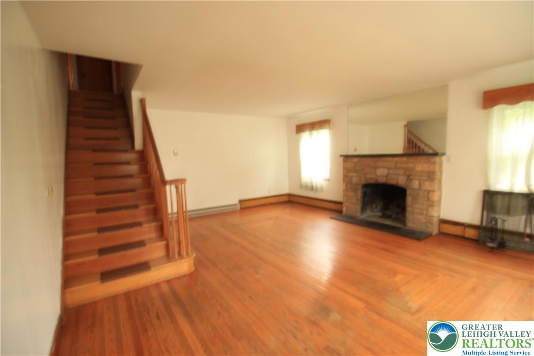419 Diamond Street, Unit B Slatington, PA 18080 - Photo 2 of 17 a view of a livingroom with wooden floor and a fireplace