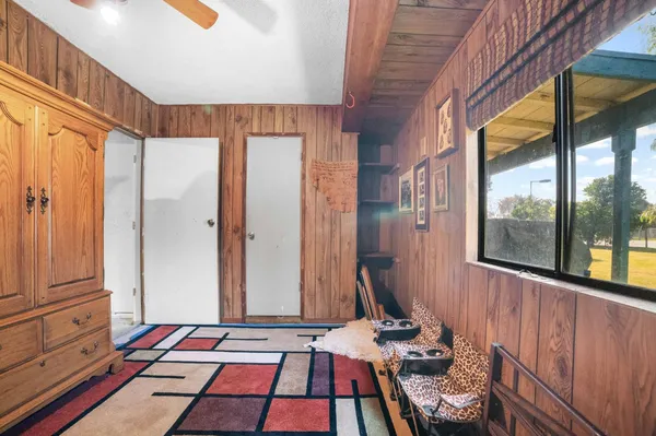 a bedroom with furniture and a large window