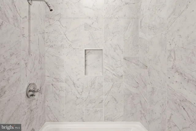 a bathroom with a glass door shower and a sink