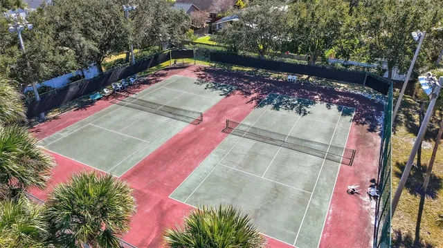 a view of a balcony with chairs and wooden fence
