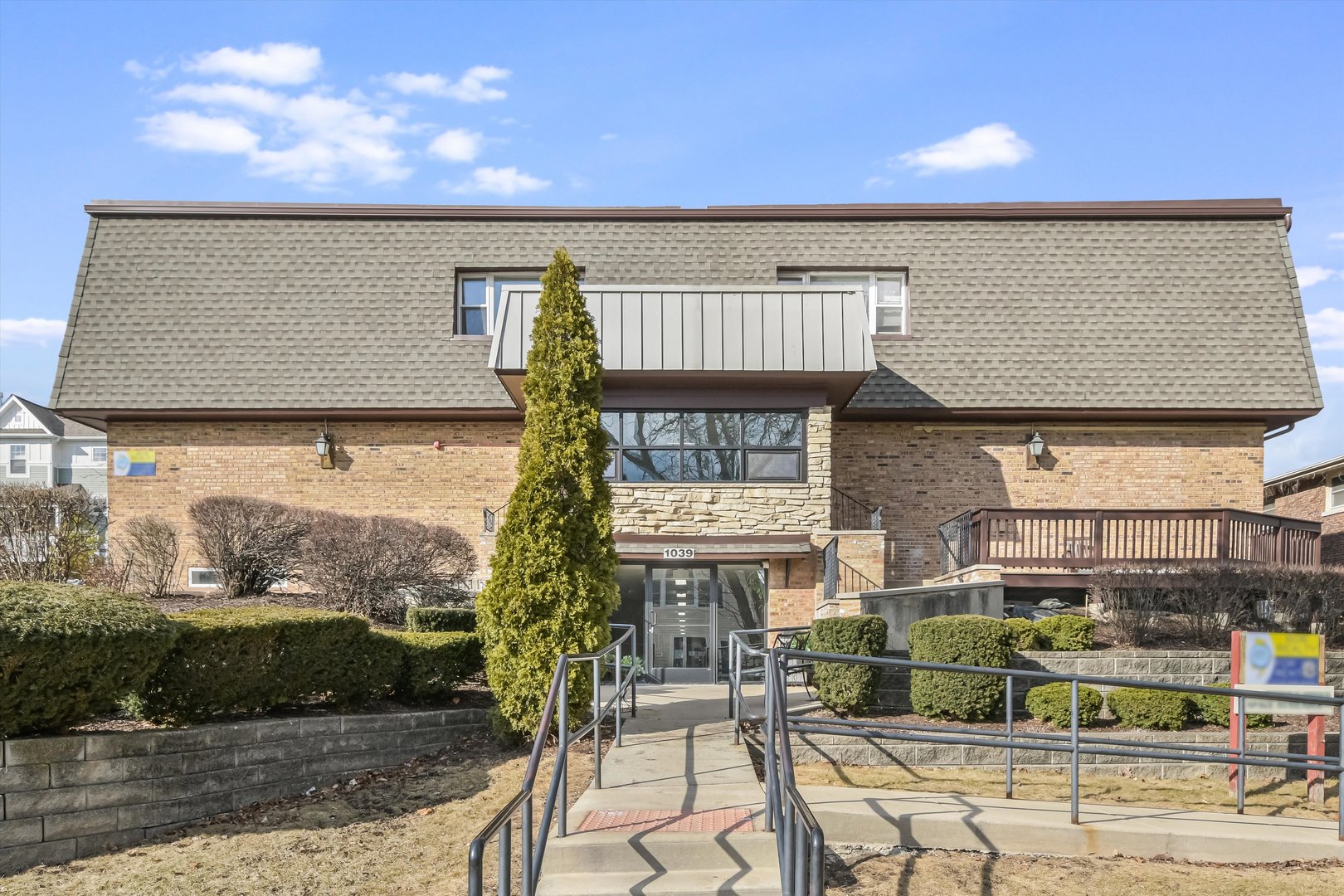 1039 College Avenue, Unit 2E Wheaton, IL 60187 - Photo 1 of 18 a front view of a building with street view