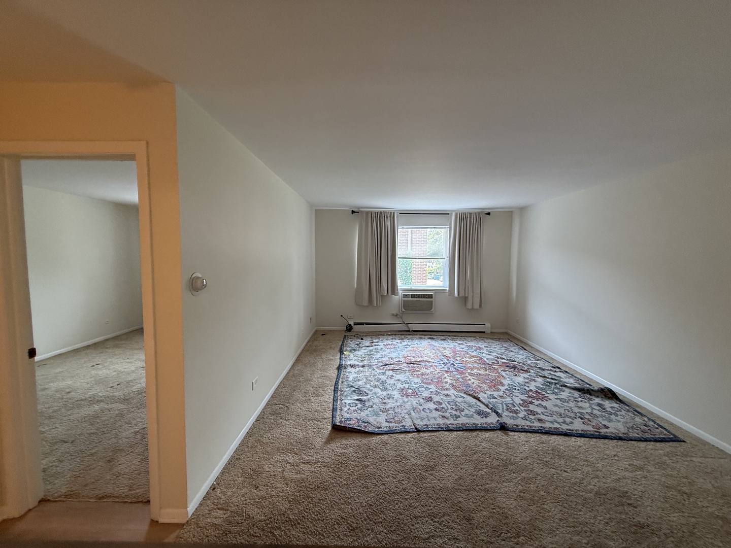1039 College Avenue, Unit 2E Wheaton, IL 60187 - Photo 12 of 18 a view of an empty room and window