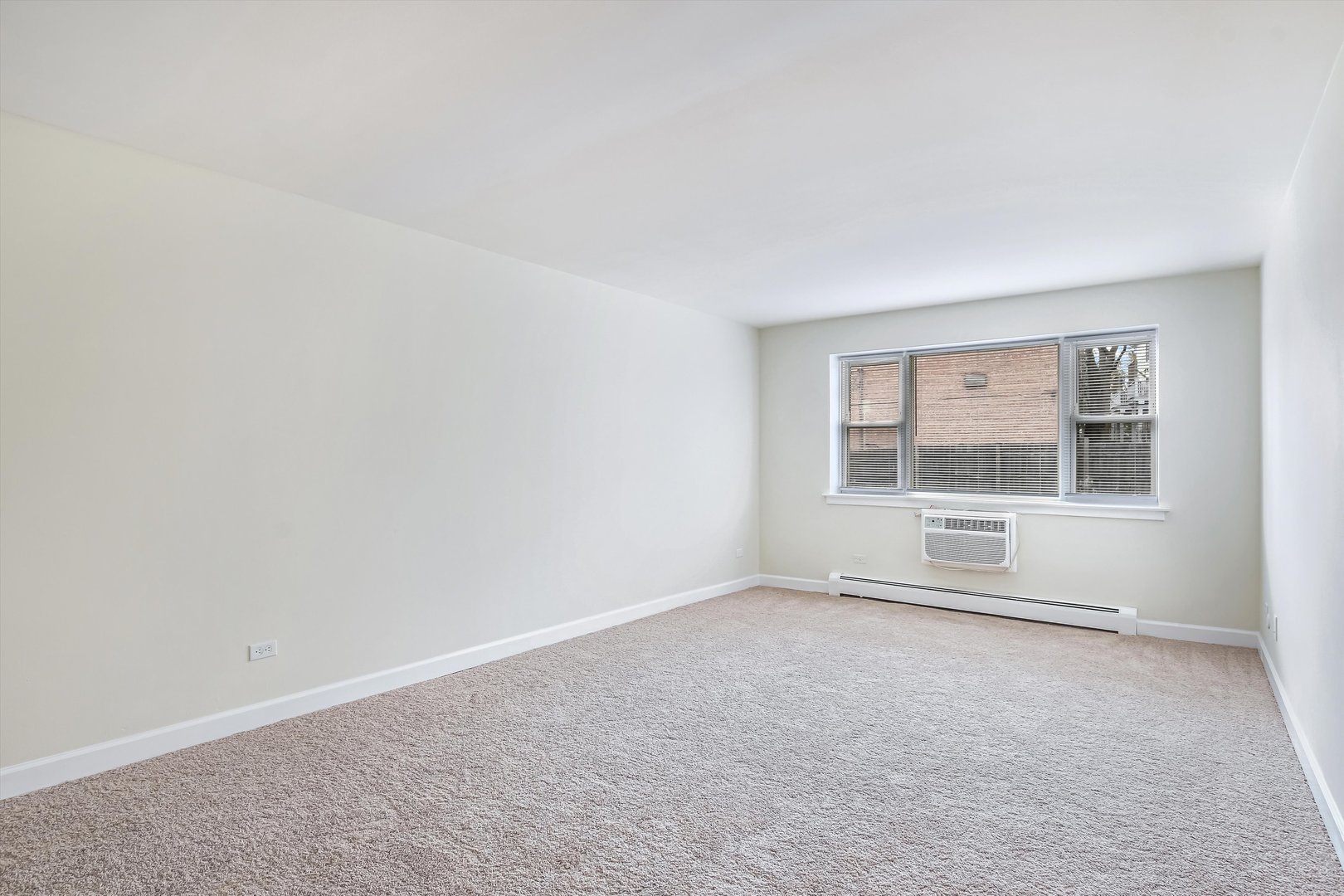 1039 College Avenue, Unit 2E Wheaton, IL 60187 - Photo 5 of 18 an empty room with a empty space and window