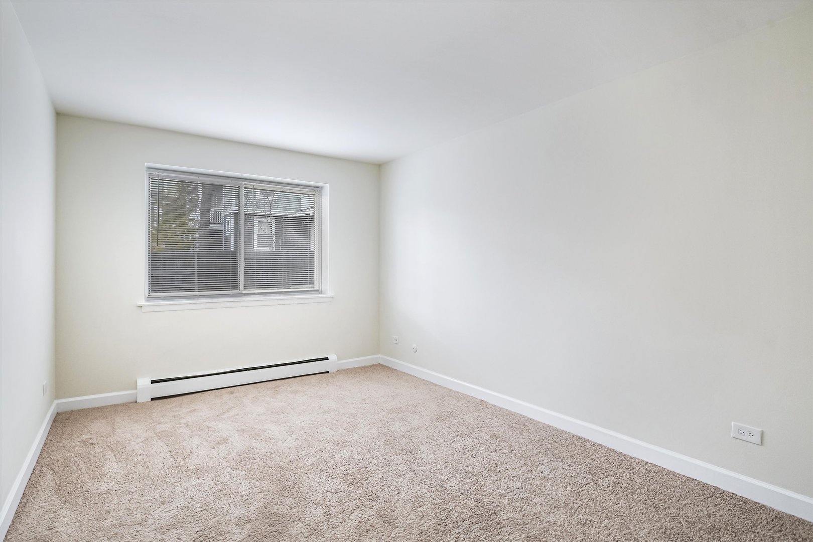 1039 College Avenue, Unit 2E Wheaton, IL 60187 - Photo 7 of 18 a view of an empty room with a window