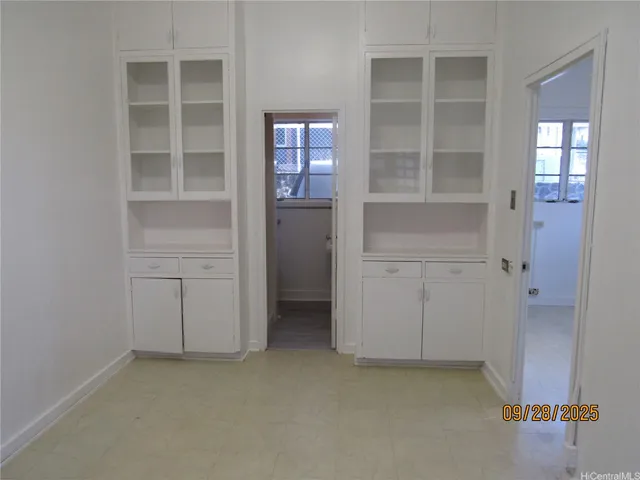 an empty room with windows and closet