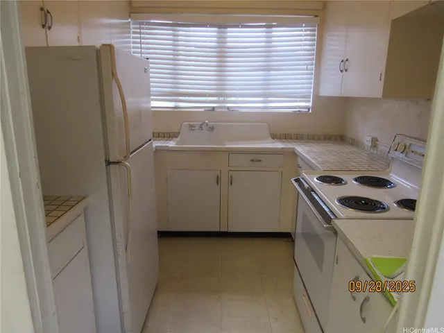 a kitchen with a refrigerator and a sink