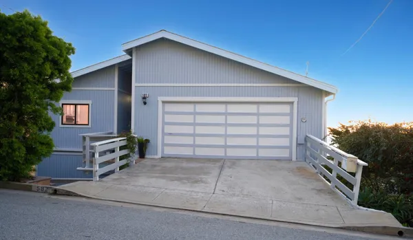 a view of a house with a yard and garage