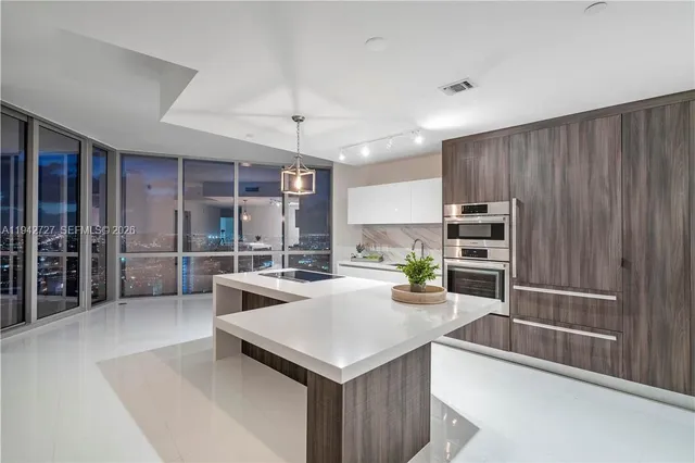 a kitchen with a stove a refrigerator and a sink