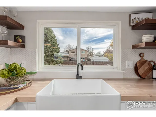 a living room with a window and a wooden floor