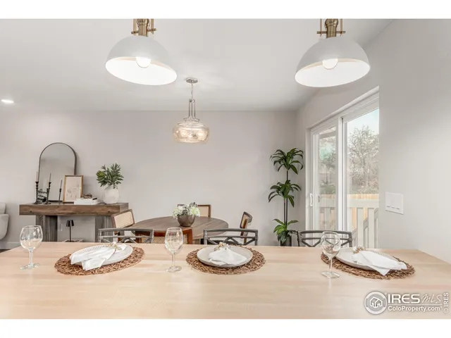 a dining room with furniture and a chandelier