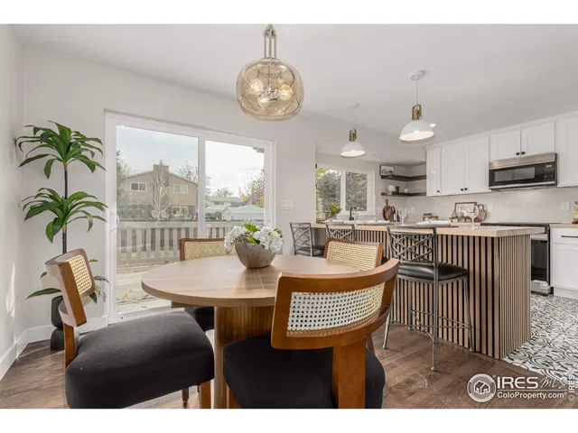 a dining room with furniture a window and a chandelier