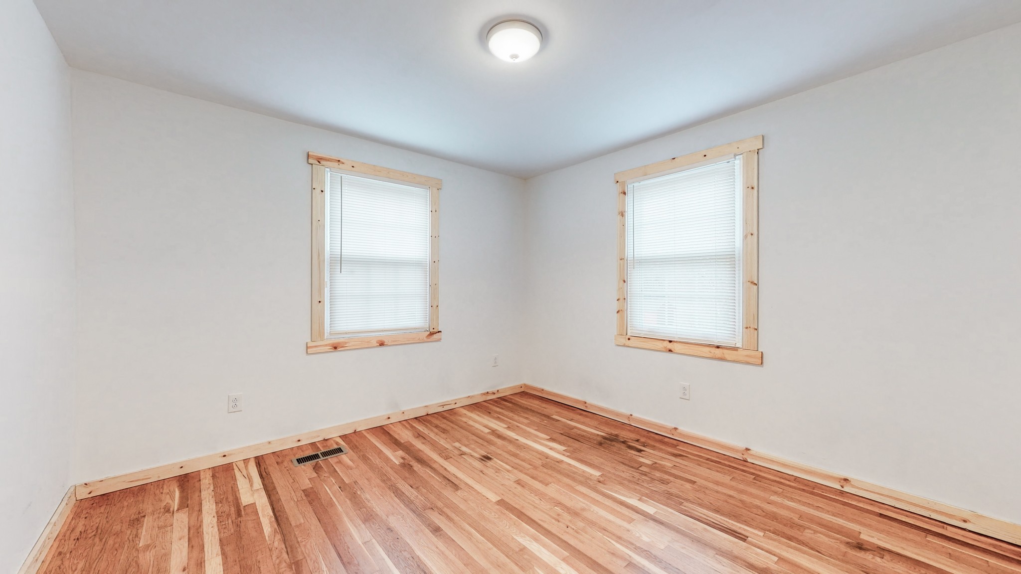 819 Neelys Bend Road Madison, TN 37115 - Photo 18 of 48 an empty room with wooden floor and windows