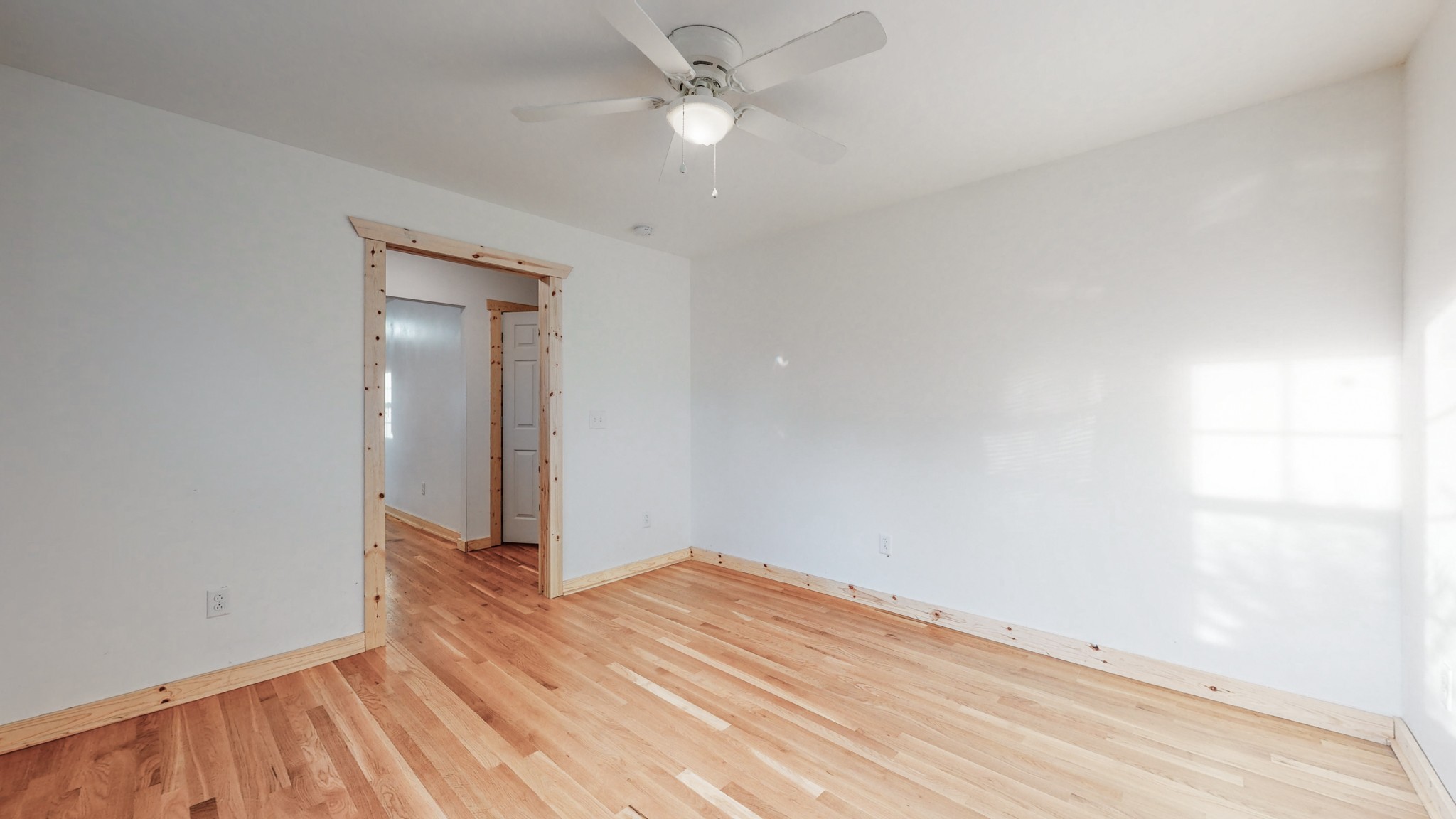 819 Neelys Bend Road Madison, TN 37115 - Photo 3 of 48 an empty room with wooden floor and fan