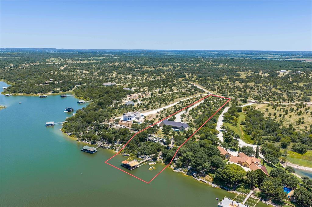 1005 Deep Water Road May, TX 76857 - Photo 5 of 40 Waterfront lakeside community featuring expansive tree-lined grounds, custom residences with varied architectural styles, manicured landscaping, private waterfront access with boat docking facilities, and winding streets throughout the developed neighborhood