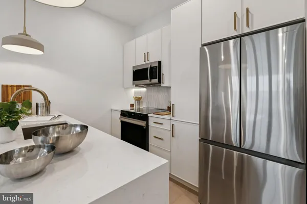 a kitchen with a refrigerator and a sink