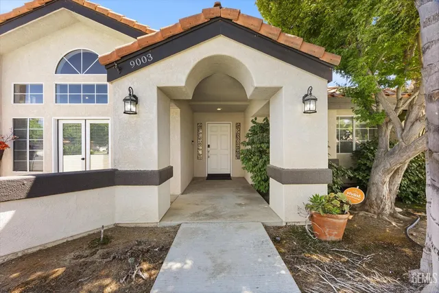 a view of a hallway with wooden floor and a dining table
