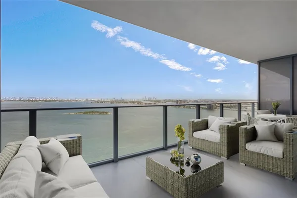 a living room with furniture and a floor to ceiling window